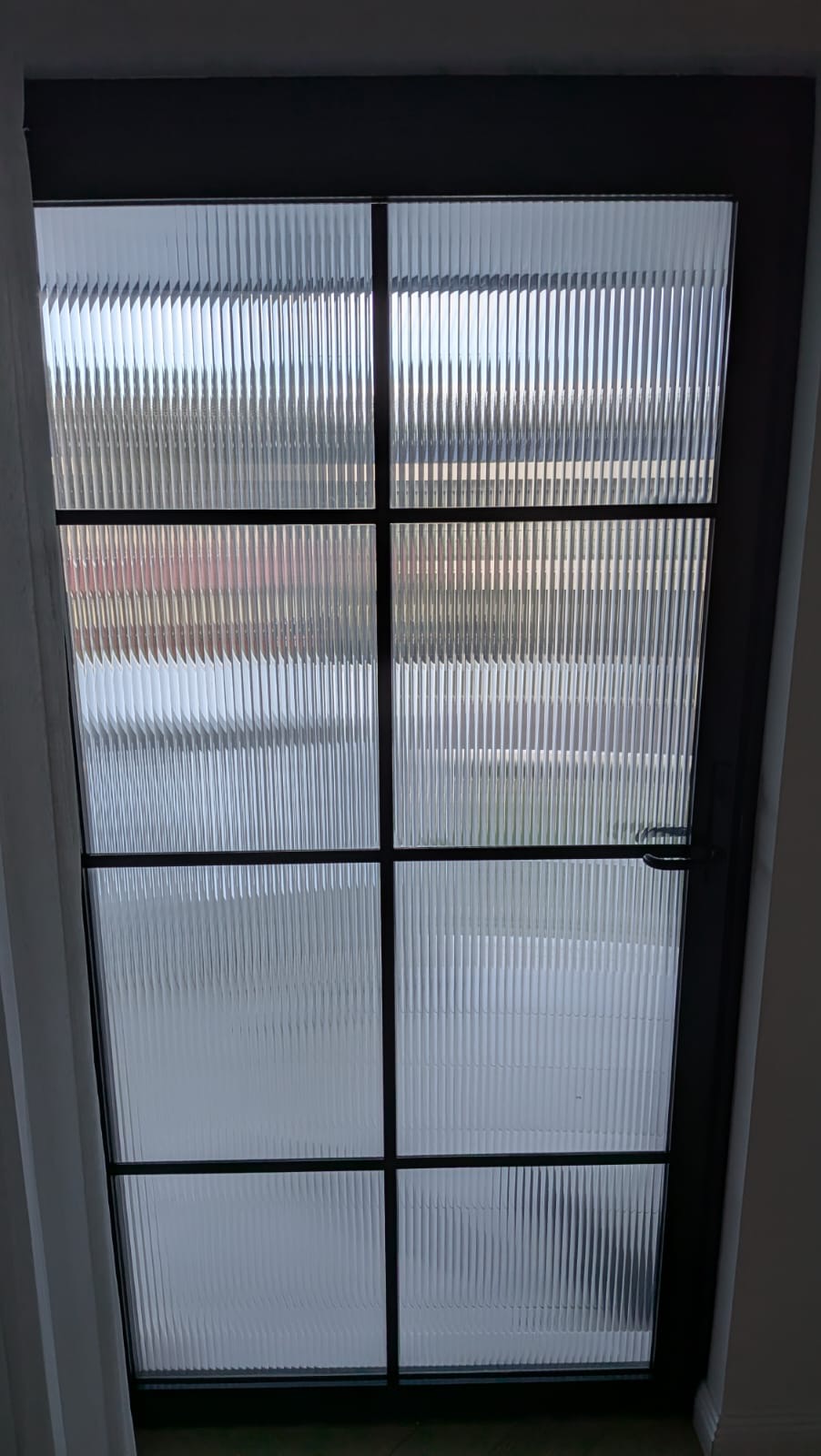 Reeded glass door with decorative film