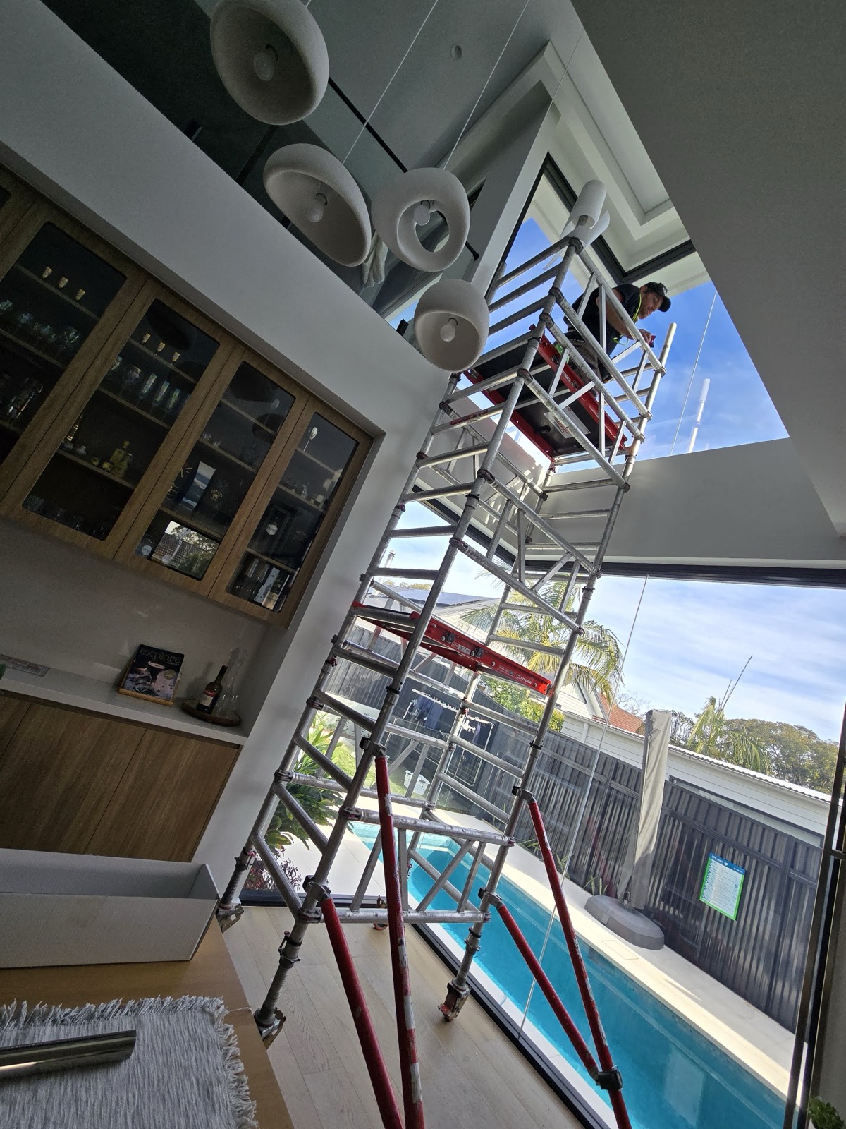 TintCo installers working from a scaffold on commercial glazing