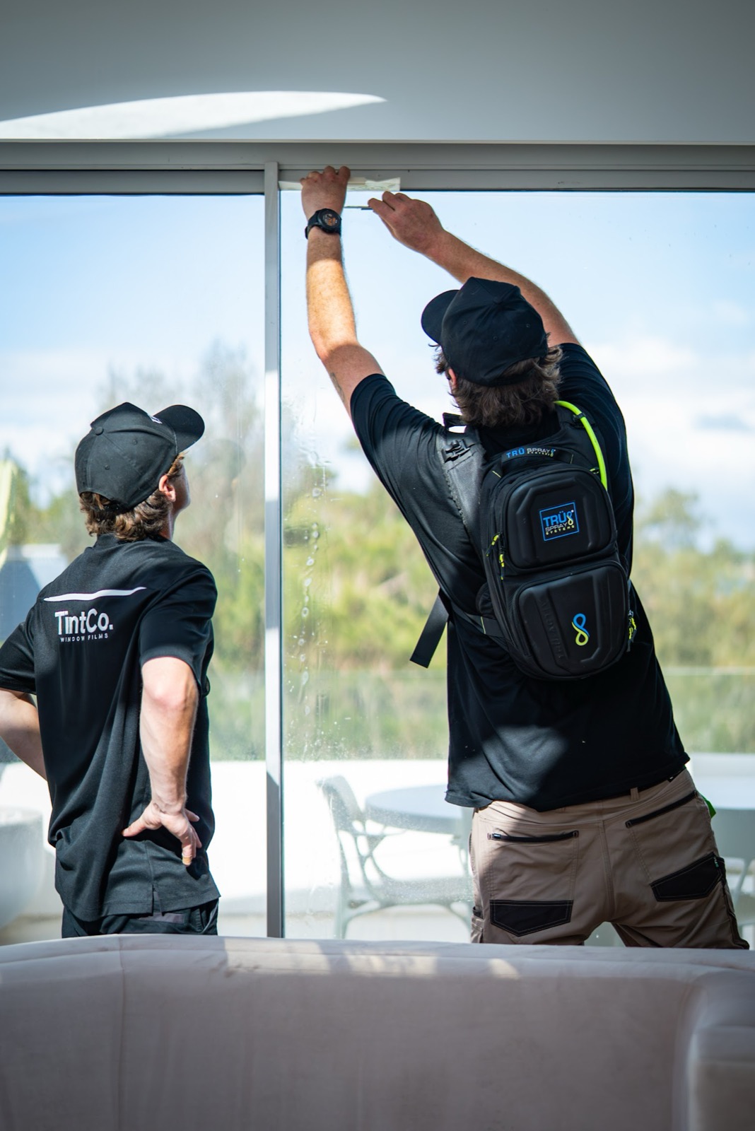 TintCo installers applying thermal film to commercial glass